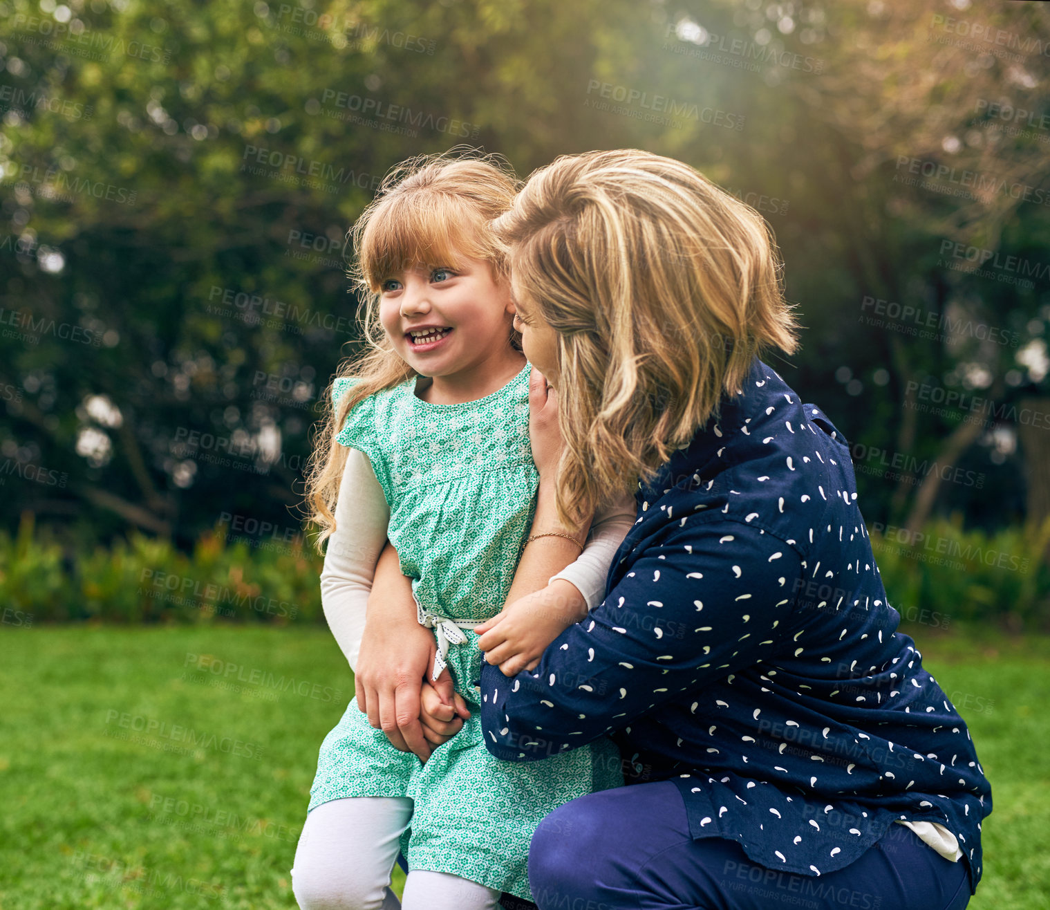 Buy stock photo Mother, girl and happy on hug at park for fun, bonding and care on break for child development or growth in France. Parent, kid and smile in garden with playing on lawn, relax and chill for support