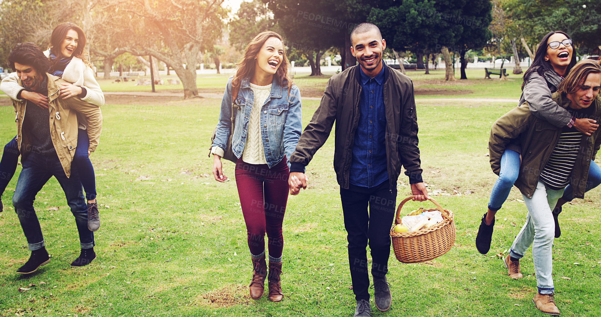 Buy stock photo Shot of young friends on their way to picnic outside