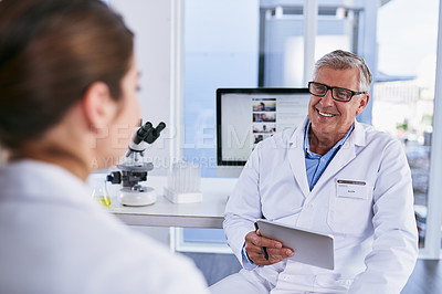 Buy stock photo Shot of two scientists having a discussion in a lab