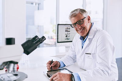 Buy stock photo Portrait of a mature scientist working on a digital tablet in a lab