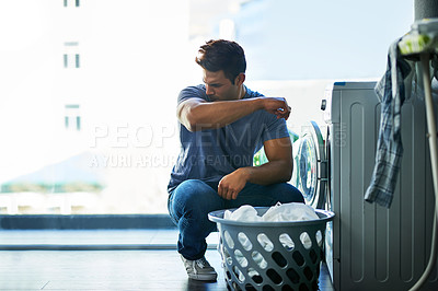 Buy stock photo Shot of a young man doing household chores