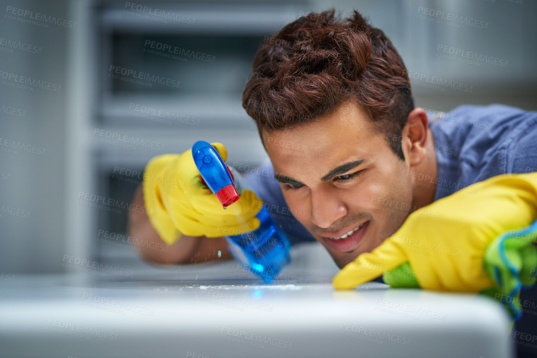 Buy stock photo Spray, cleaning and man with gloves, home and routine for hygiene for chores, sanitary and equipment. House, tidy and person with bottle for disinfection, product or chemical for polishing of surface