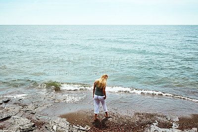 Buy stock photo Above, woman and walk at beach for travel, adventure and explore nature on holiday. Back, female person and calm morning with ocean water, weekend break and fresh air with space for tropical vacation