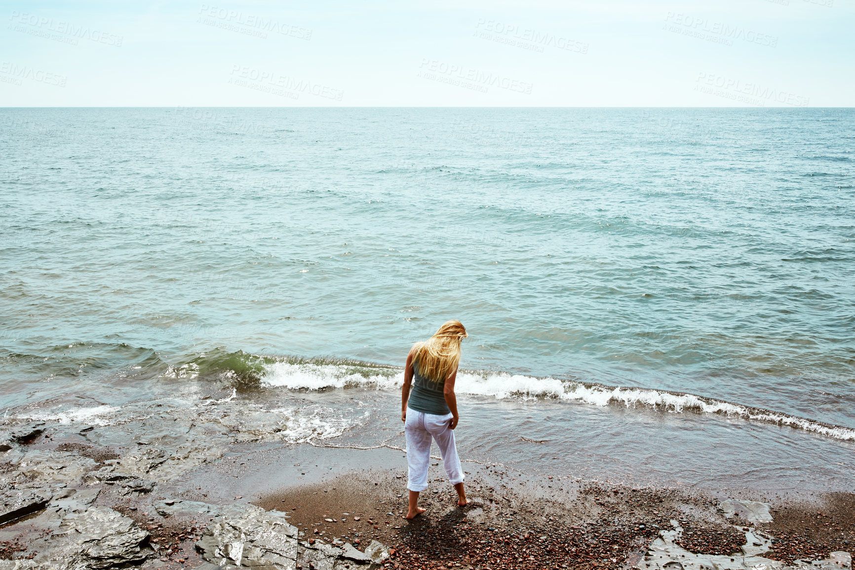 Buy stock photo Above, woman and walk at beach for travel, adventure and explore nature on holiday. Back, female person and calm morning with ocean water, weekend break and fresh air with space for tropical vacation