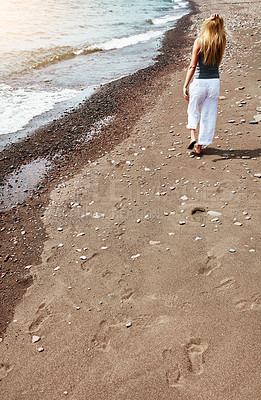Buy stock photo Back, woman and walk at beach for travel, adventure and explore nature on holiday. Above, female person and calm morning with ocean water, weekend break and fresh air on seashore of tropical vacation