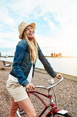 Buy stock photo Woman, travel and outdoor with bicycle, laugh and streetwear on summer holiday, fresh air and relax. Traveler, smile and person with eco friendly transport for trip in nature, adventure and break