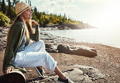 Buy stock photo Thinking, relax and woman on beach with smile, outdoor holiday and calm nature on an island. Travel, peace and girl in hat on ocean vacation with water, trees and morning inspiration in Norway