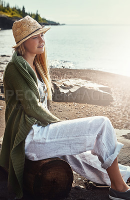 Buy stock photo Shot of a young woman spending a day at the lake