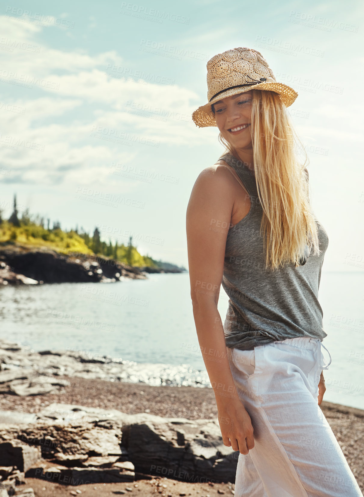 Buy stock photo Shot of a young woman spending a day at the lake