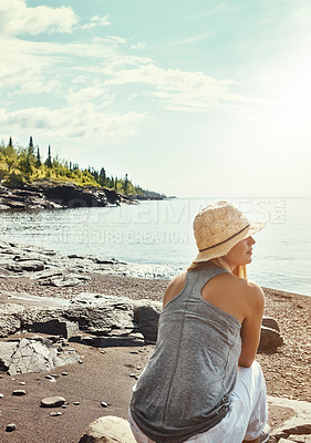 Buy stock photo Shot of a young woman spending a day at the lake