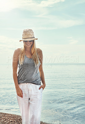 Buy stock photo Relax, sunglasses and happy woman at beach on vacation, holiday or travel outdoor on island in Greece. Ocean, smile and girl at sea for journey, adventure or tourist on trip in nature with summer hat