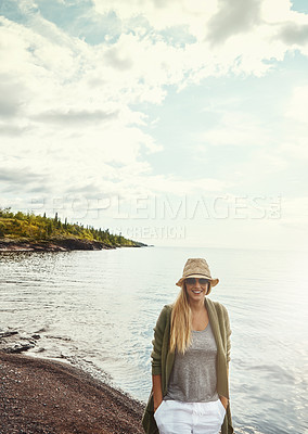 Buy stock photo Shot of a young woman spending a day at the lake