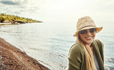 Buy stock photo Happy woman, portrait and hat with glasses at beach for holiday, weekend or outdoor getaway. Young female person with smile in fashion for break, journey or trip in happiness by ocean coast in nature
