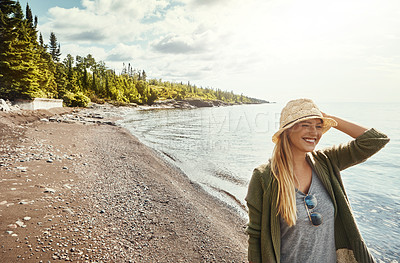 Buy stock photo Happy woman, laughing and beach with hat for walk, holiday weekend or outdoor getaway on island in sunshine. Young female person with smile for fun journey, trip or happiness by ocean coast in nature