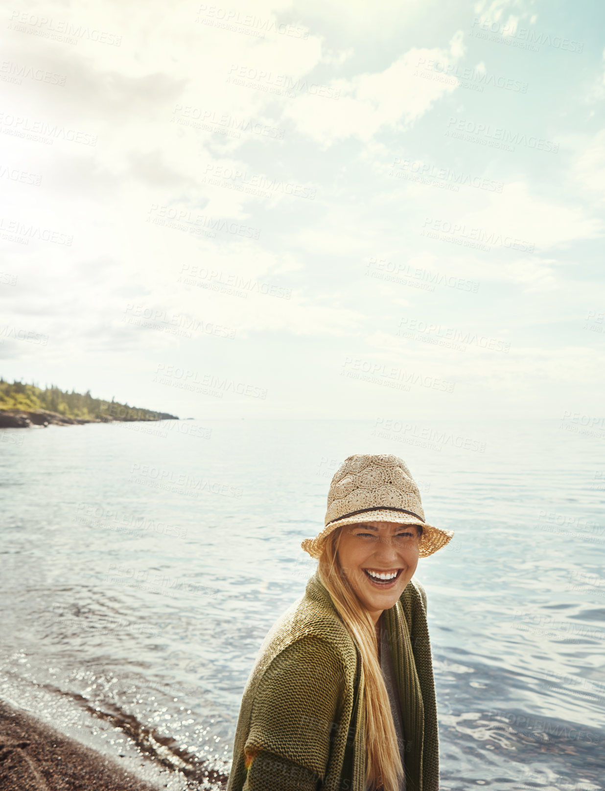 Buy stock photo Happy, space and woman by beach for holiday, getaway or weekend trip with relax by water. Laugh, sun hat and female person by ocean for seaside vacation with calm, peace and smile outdoor with travel