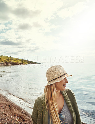 Buy stock photo Shot of a young woman spending a day at the lake