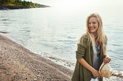 Buy stock photo Shot of a young woman spending a day at the lake