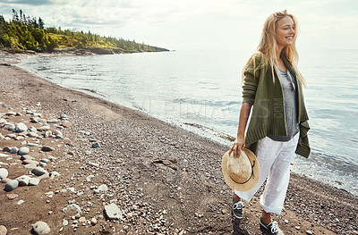 Buy stock photo Shot of a young woman spending a day at the lake