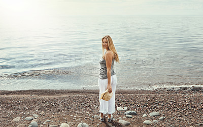 Buy stock photo Shot of a young woman spending a day at the lake