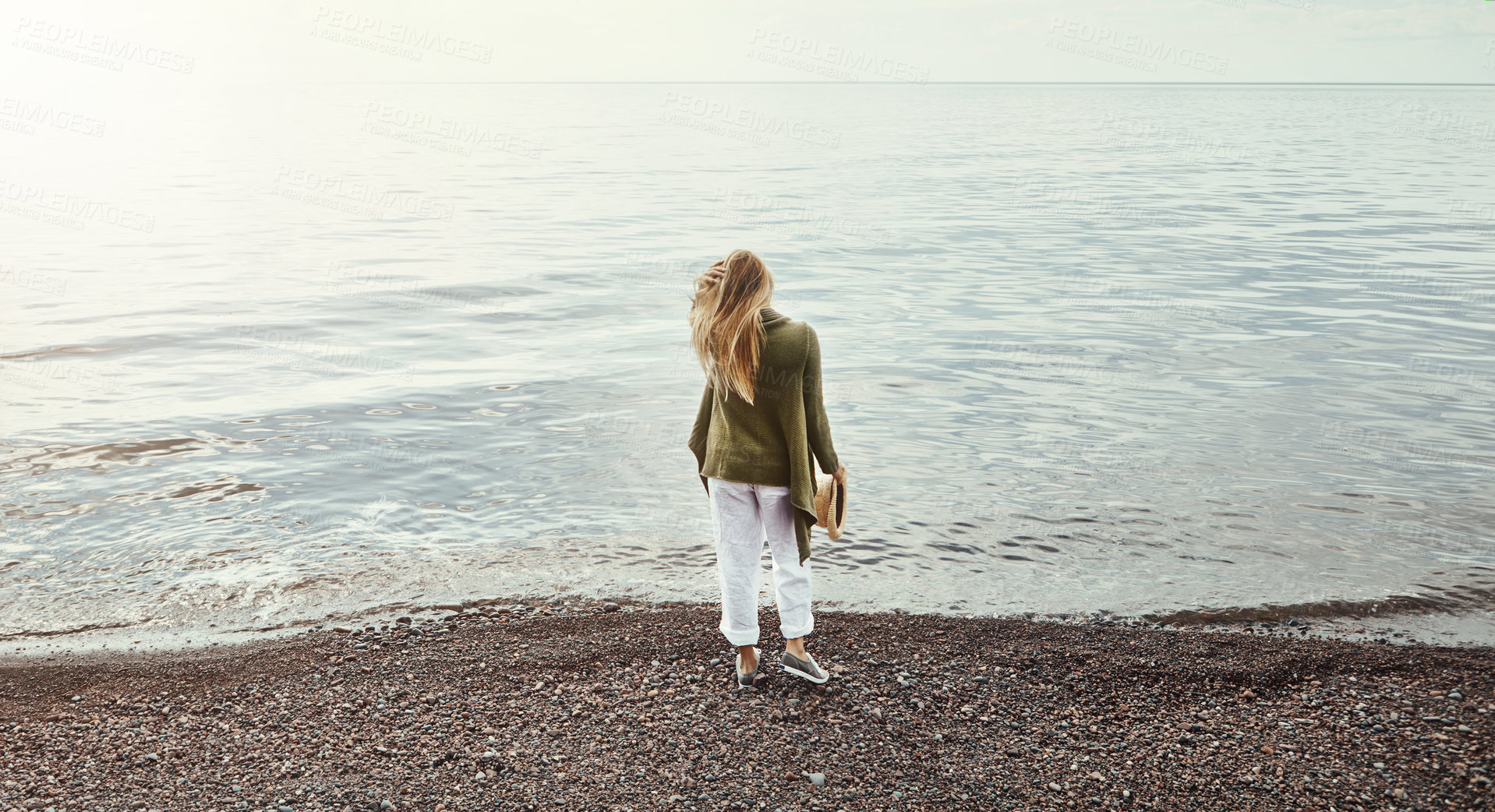 Buy stock photo Shot of a young woman spending a day at the lake