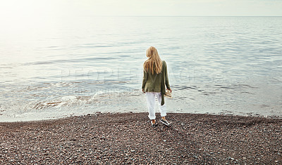 Buy stock photo Shot of a young woman spending a day at the lake