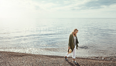 Buy stock photo Shot of a young woman spending a day at the lake