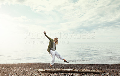 Buy stock photo Balance, beach and woman walking on log outdoor in summer for hobby, leisure or vacation. Earth, freedom and sky with person having fun by ocean for break or fresh air, holiday and weekend trip