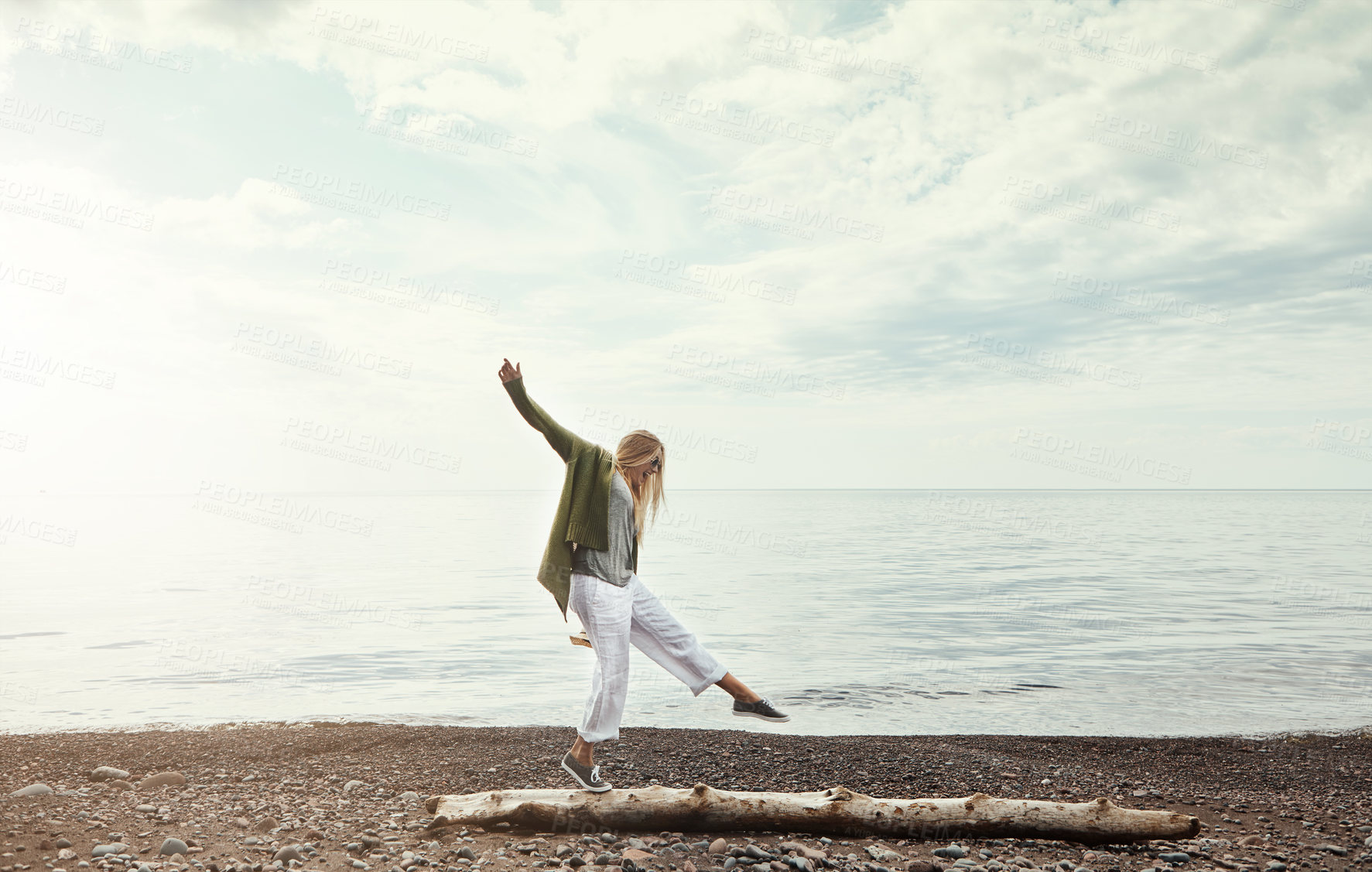 Buy stock photo Balance, beach and woman walking on log outdoor in summer for hobby, leisure or vacation. Earth, freedom and sky with person having fun by ocean for break or fresh air, holiday and weekend trip