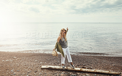 Buy stock photo Shot of a young woman walking along a log at a lake