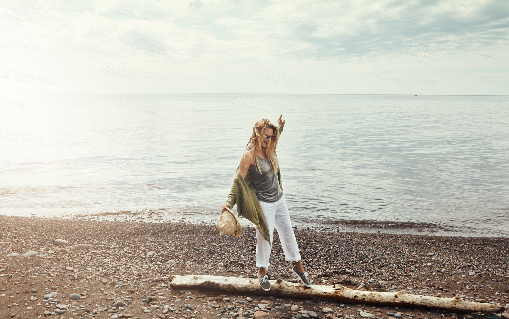 Buy stock photo Walking, branch and woman by beach on adventure, holiday or weekend trip with exploring outdoor. Space, water and female person on wood log for balance by ocean on seaside vacation for travel.