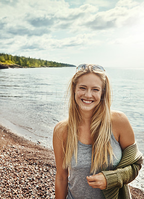 Buy stock photo Shot of a young woman spending a day at the lake