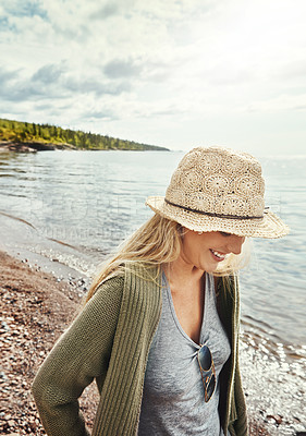 Buy stock photo Shot of a young woman spending a day at the lake