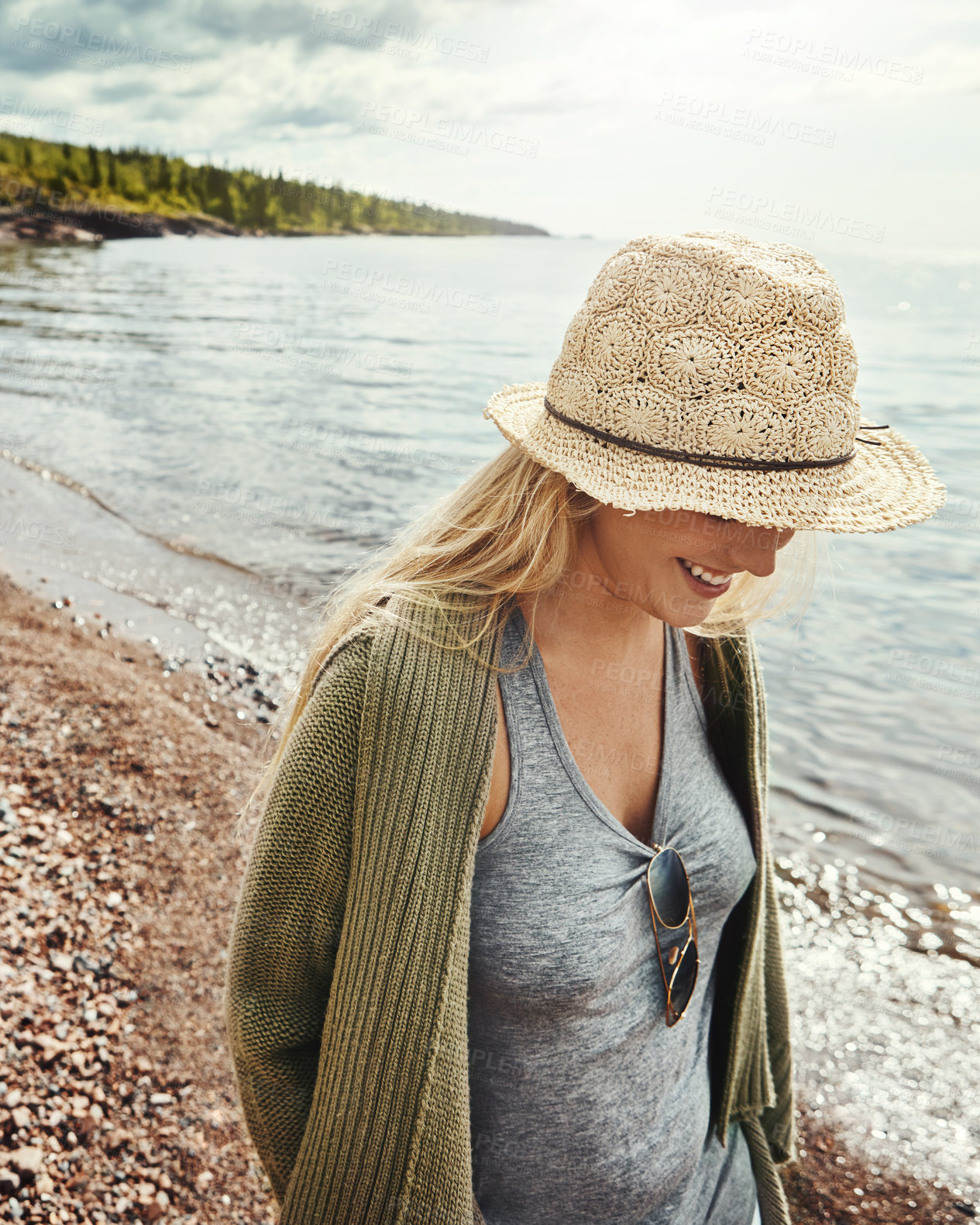 Buy stock photo Shot of a young woman spending a day at the lake