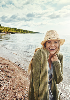 Buy stock photo Shot of a young woman spending a day at the lake