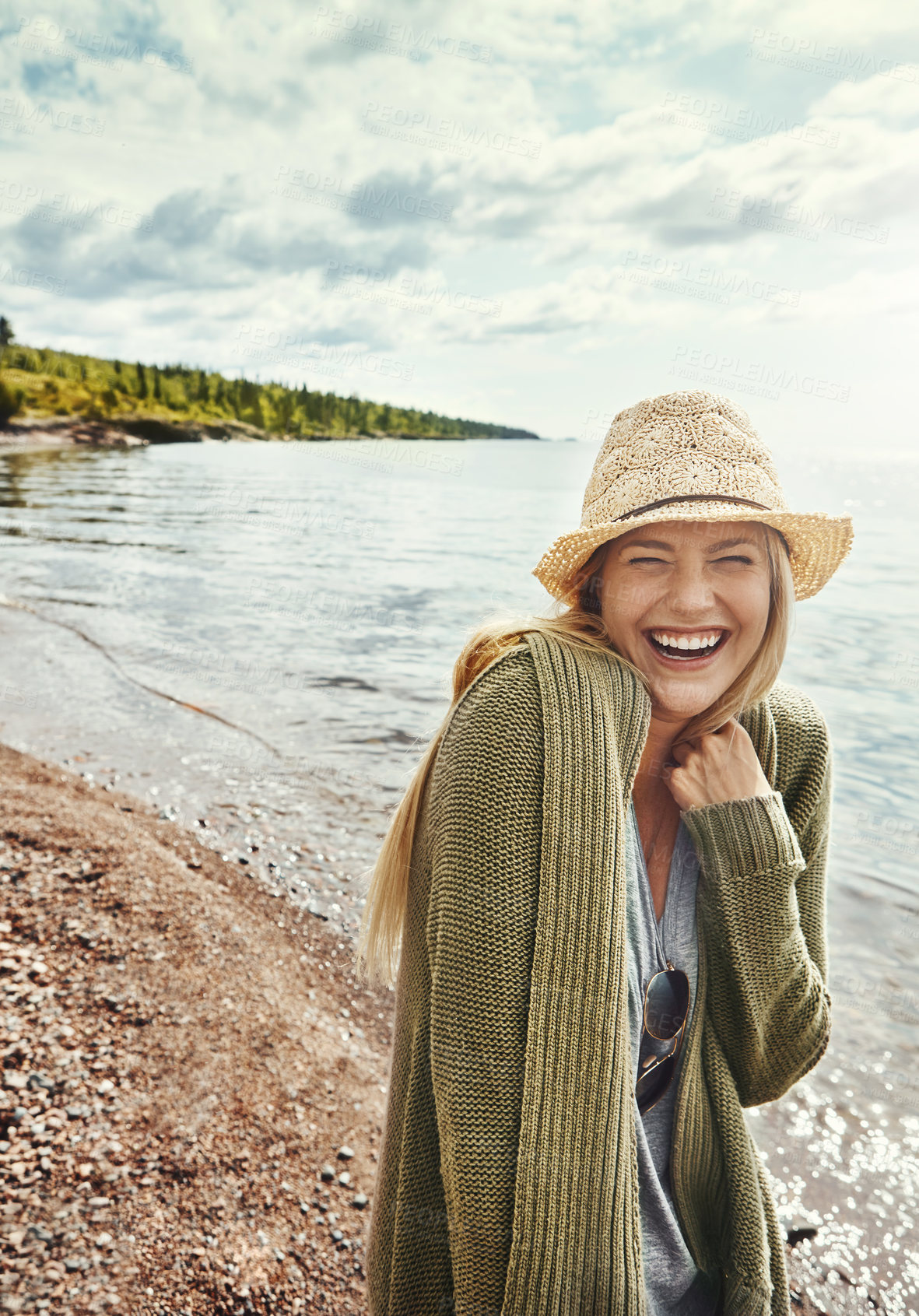 Buy stock photo Shot of a young woman spending a day at the lake