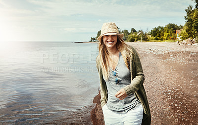 Buy stock photo Shot of a young woman spending a day at the lake