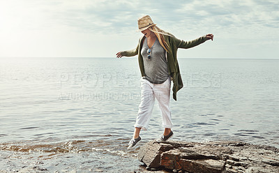 Buy stock photo Shot of a young woman spending a day at the lake