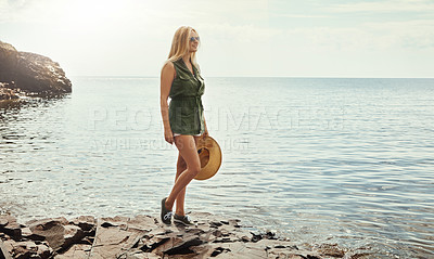 Buy stock photo Shot of an attractive young woman spending a day at the lake