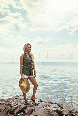 Buy stock photo Shot of an attractive young woman spending a day at the lake