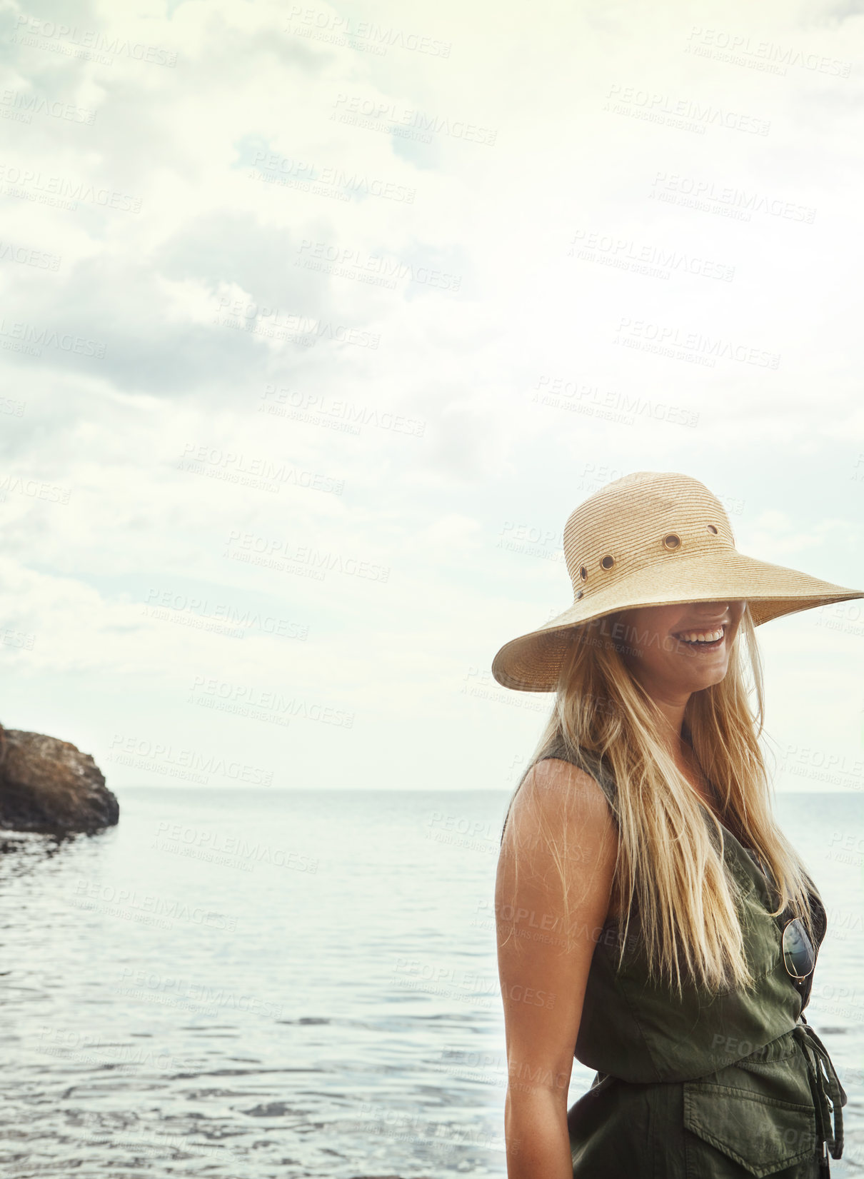 Buy stock photo Shot of an attractive young woman spending a day at the lake