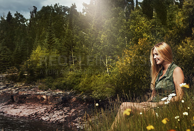 Buy stock photo Shot of an attractive young woman spending a day at the lake