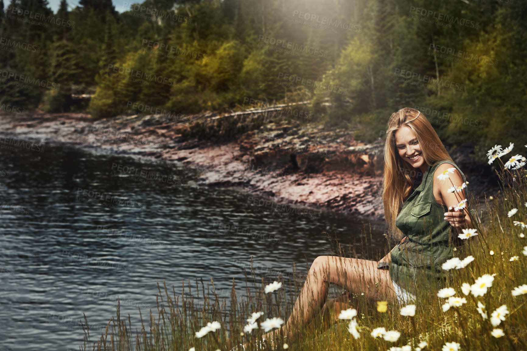 Buy stock photo Shot of an attractive young woman spending a day at the lake