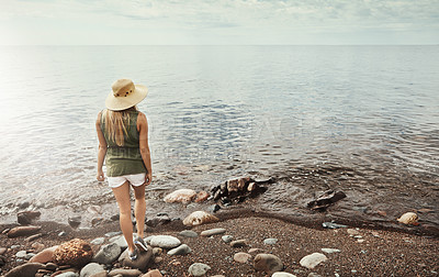 Buy stock photo Rear view shot of an attractive young woman spending a day at the lake