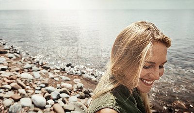 Buy stock photo Shot of an attractive young woman spending a day at the lake