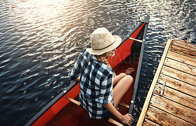 Buy stock photo High angle of an attractive young woman spending a day kayaking on the lake