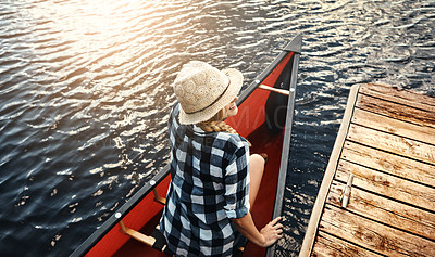 Buy stock photo High angle shot of an attractive young woman spending a day kayaking on the lake