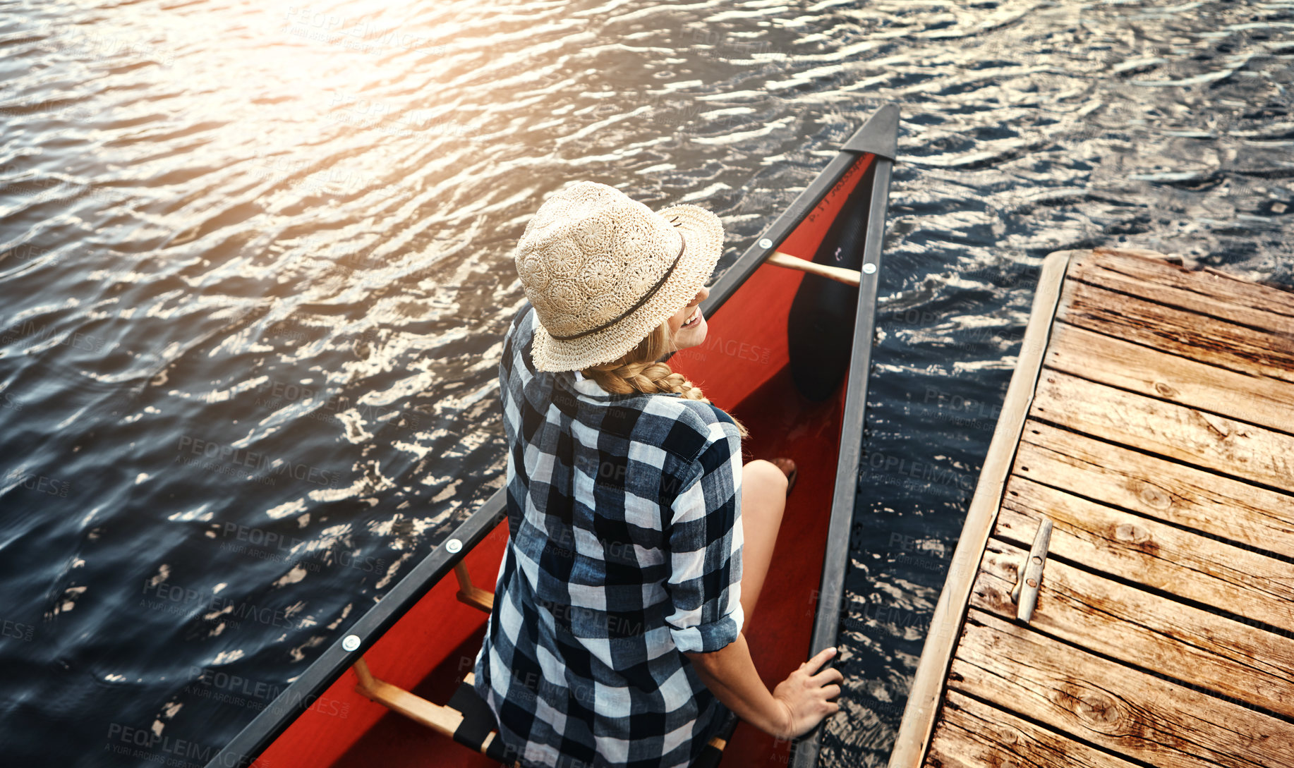 Buy stock photo High angle shot of an attractive young woman spending a day kayaking on the lake