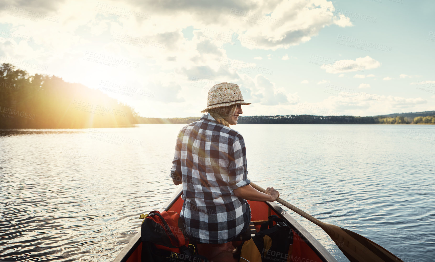 Buy stock photo Shot of an attractive young woman spending a day kayaking on the lake