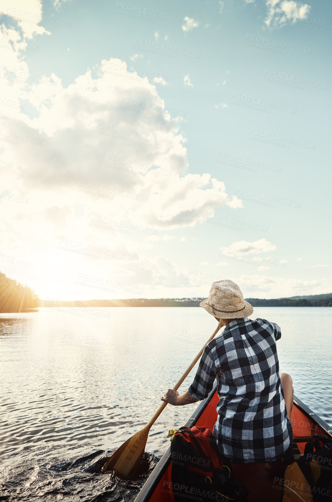 Buy stock photo Shot of an attractive young woman spending a day kayaking on the lake