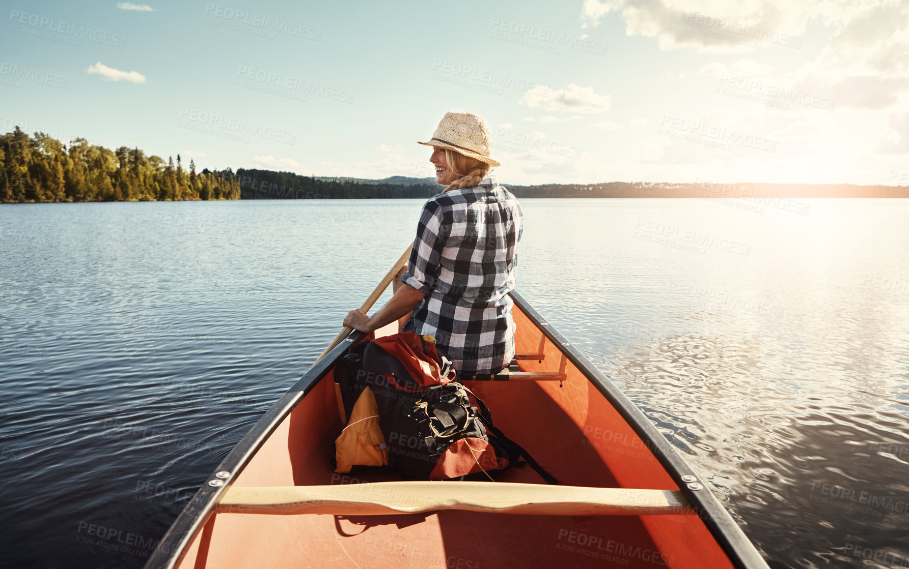 Buy stock photo Canoeing, lake and reflection with woman on vacation, rowing or explore on adventure on water. Travel, paddle and person on boat outdoor with sunshine for summer, happiness and thinking of back view